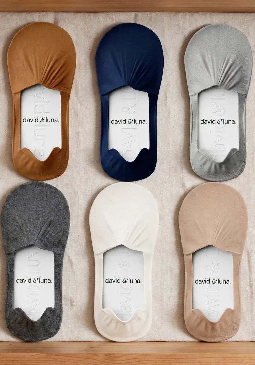 No-show socks in several colours laid out in a linen-lined drawer